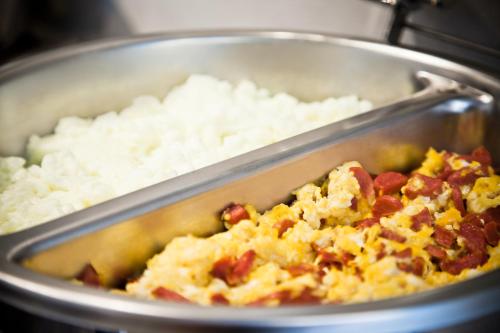 a pan full of food with rice and eggs at City Express by Marriott Hermosillo in Hermosillo