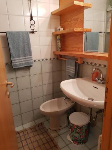 a small bathroom with a sink and a toilet at Residence Sole Alto, Località Marilleva 1400 in Marilleva