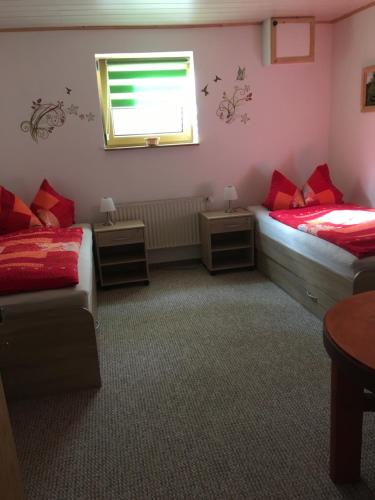 a bedroom with two beds and a window and a couch at Zum Stadtwald in Spremberg