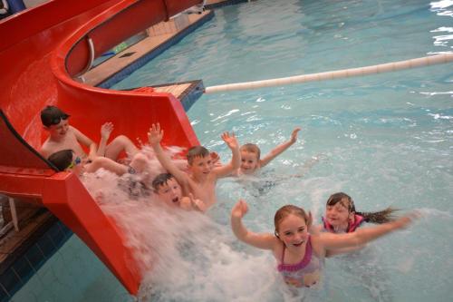 a group of children playing in a swimming pool at Causeway Coast Apartment in Ballycastle