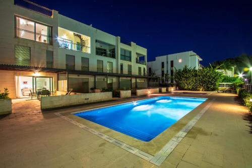 a large swimming pool in front of a building at Duplex La Nau By homevillas360 in Port de Pollensa