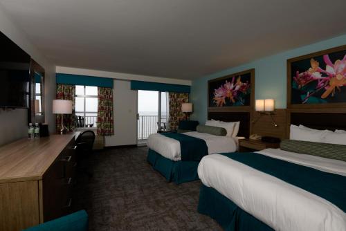 a hotel room with two beds and a desk at Rod 'N' Reel Resort in Chesapeake Beach