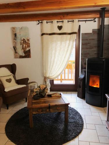 a living room with a coffee table and a fireplace at La Chambre des Rêves in Aosta
