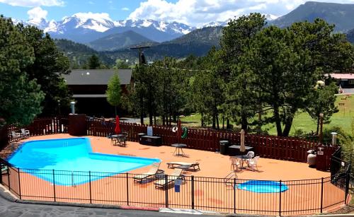 a beach with a pool and a tennis court at Hotel Estes in Estes Park