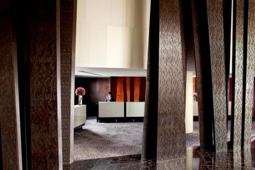 a lobby with a man sitting at a desk at The Langham, Shanghai, Xintiandi in Shanghai