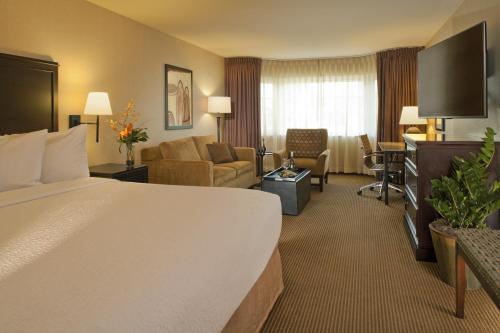 a hotel room with a bed and a living room at Silver Cloud Hotel - Seattle Broadway in Seattle