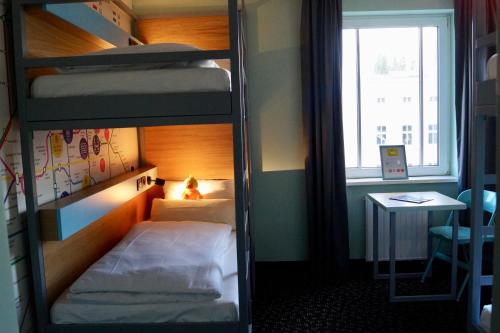 a small room with a bunk bed and a window at Grand Hostel Berlin Urban in Berlin