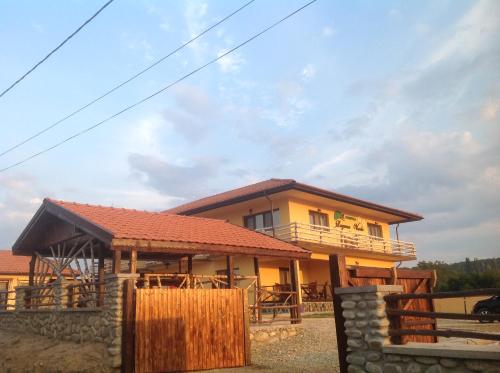 a house with a balcony on top of it at Laguna Verde in Crivina