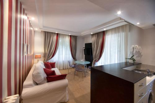 a living room with a white couch and a table at Residence Lungomare - Charming apartments in Riccione
