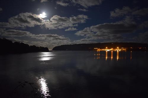 a full moon rising over a lake at night at Shearwater Country House Accommodation in Union Hall
