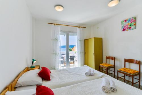 a bedroom with two beds and a view of the ocean at Apartments Citrus in Turanj