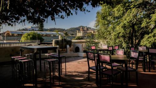 a group of tables and chairs in a park at Agrado Guest House in Oaxaca City