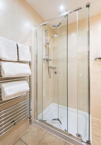 a shower in a bathroom with a glass shower stall at Rosehill Guest House in Pitlochry