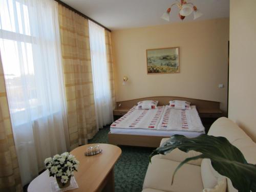 a small room with a bed and a table at Livonija in Sigulda