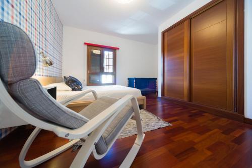 a room with a rocking chair and a bed at Aquavilla in Costa Teguise
