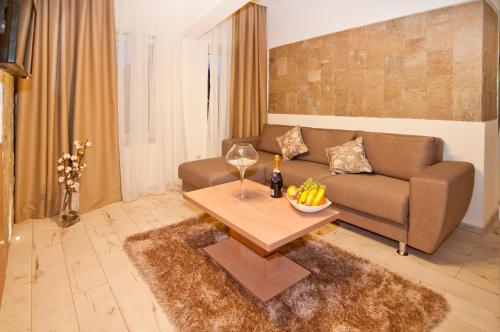 a living room with a couch and a table at Hotel Confort in Cluj-Napoca