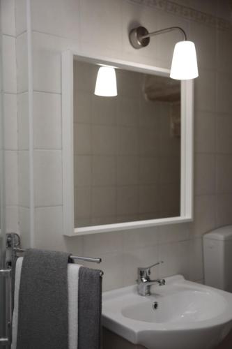 a bathroom with a sink and a mirror and a towel at B&B Casa AMALIA in Barletta