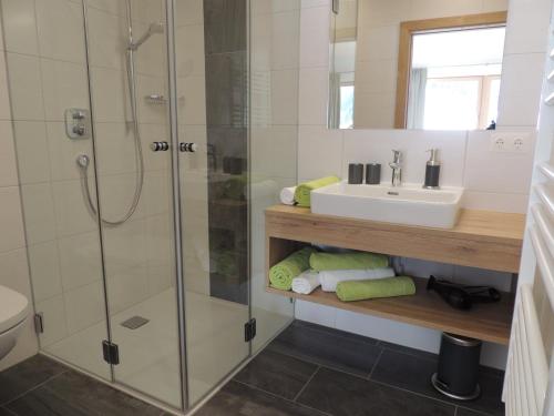 a bathroom with a shower and a sink at Buttererhof-Apartments in Fulpmes