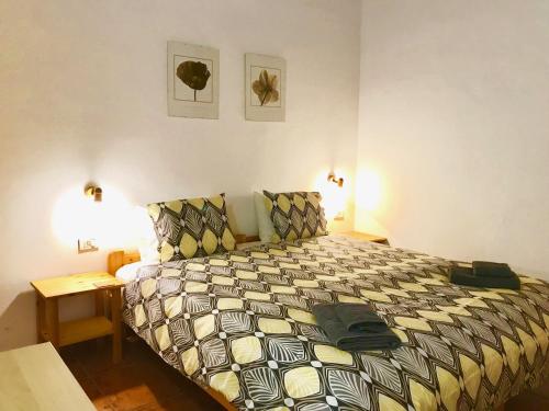 a bedroom with a bed in a room with two lamps at Casita Brego - A Tranquil and Restful Rural Retreat! in San Sebastián de la Gomera