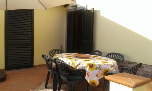 a table and chairs with a table and an umbrella at CA' MENEGHETTI in Massaciuccoli
