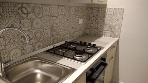 a kitchen with a stove and a sink at Belle Arti in Palermo