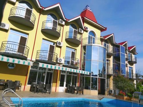 a building with a pool in front of it at Delta Hotel in Ureki