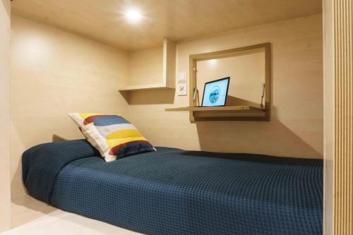 a bedroom with a large bed with a mirror at TAKE SURF Hostel Conil in Conil de la Frontera