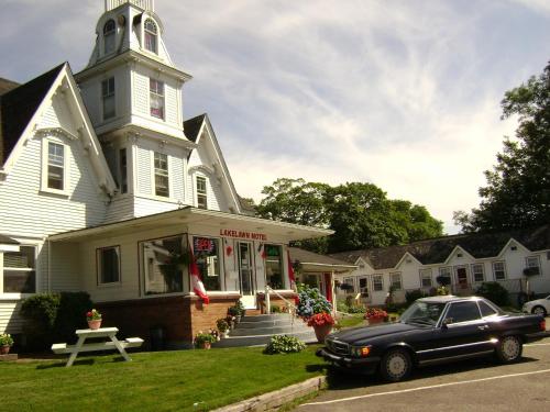 a black car parked in front of a church at Lakelawn B&B and Motel in Yarmouth