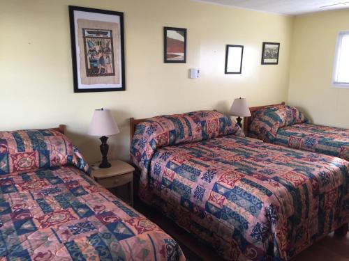 a hotel room with two beds and a couch at Lakelawn B&B and Motel in Yarmouth