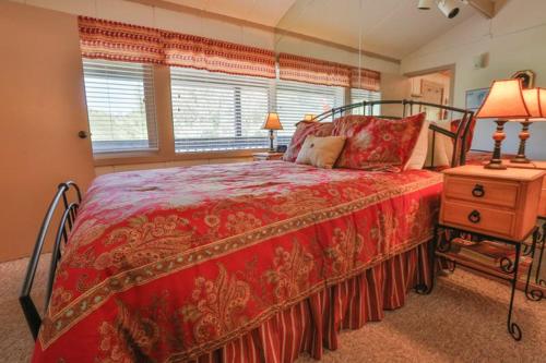sypialnia z łóżkiem z czerwoną narzutą w obiekcie Brettelberg Slopeside Condos E9 w mieście Carbondale