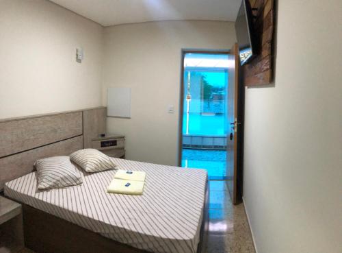 a small bedroom with a bed with a tray on it at Hotel Butantã in Sao Paulo