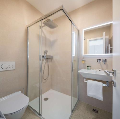 a bathroom with a shower and a toilet and a sink at Mediterra Residence in Split