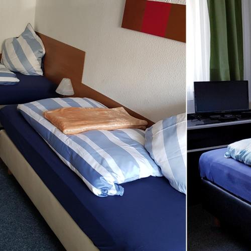 a bedroom with a bed with a laptop on it at Hotel Garni in Herborn