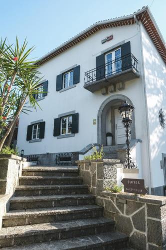a white building with stairs in front of it at 4U Lisbon VI Guesthouse Airport in Lisbon