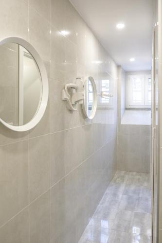a bathroom with a mirror and a shower at 4U Lisbon VI Guesthouse Airport in Lisbon