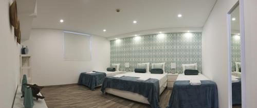 a room with two beds in a room at 4U Lisbon VI Guesthouse Airport in Lisbon