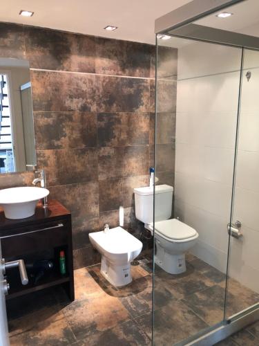 a bathroom with two toilets and a glass shower at Penthouse 603 in Montevideo