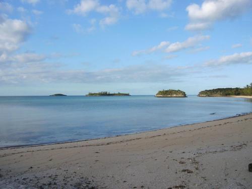 a beach with two islands in the water at Sir Charles Guest House in South Palmetto Point