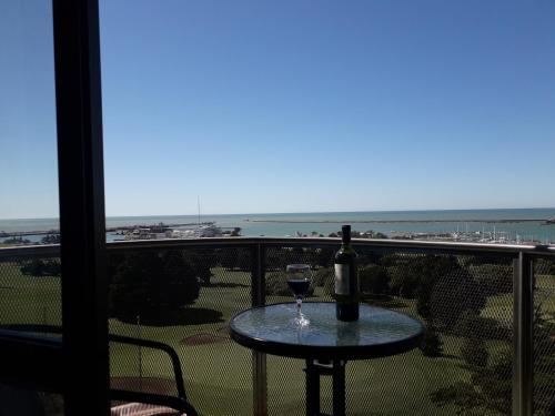 a glass of wine sitting on a table on a balcony at ESPECTACULAR Alem 5007 piso 7 in Mar del Plata