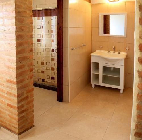 a bathroom with a sink and a shower at CABAÑAS AGUARI in Santa Rosa de Calamuchita