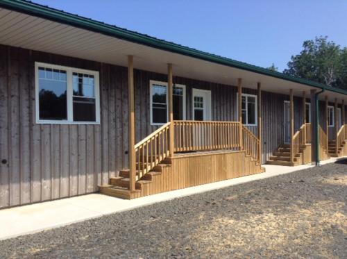a building with a porch and stairs on it at Apartment with 2 Bed Roms perfect for 4 Guests! Minimum stay 28 nights in Deep Brook