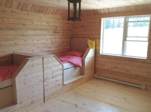 a room with two bunk beds in a log cabin at Farm Retreat with 2 Bed Roms perfect for 4 Guests! in Deep Brook