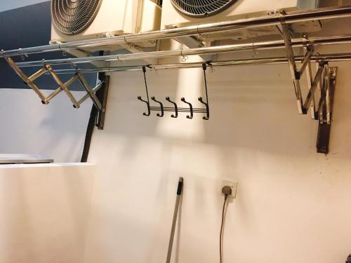 a kitchen with a rack of utensils on the wall at Perfect Getaway @Vivacity in Kuching