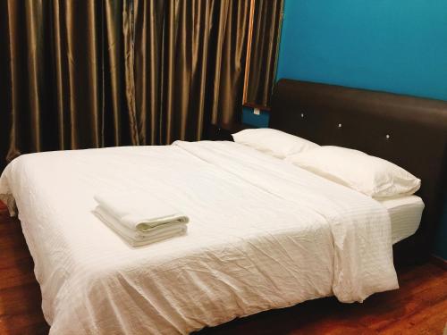 a white bed with two white towels on it at Perfect Getaway @Vivacity in Kuching