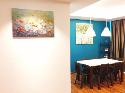 a dining room with a table and a painting on the wall at Perfect Getaway @Vivacity in Kuching