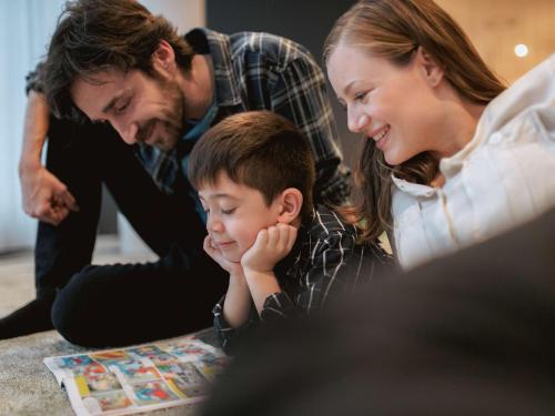 a family playing a board game with a child at Mercure Paris Boulogne in Boulogne-Billancourt
