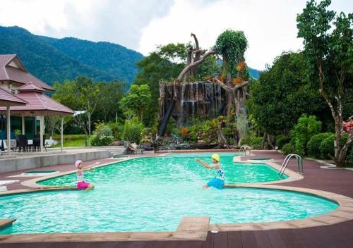 a group of people in a pool at a resort at Akantuka Homestay in Chanthaburi