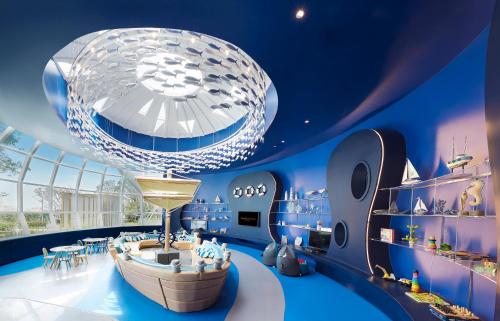 a large blue room with a large chandelier at Grande Centre Point Pattaya in Pattaya Central