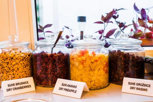 a group of jars filled with different types of food at Garden Hotel in Zagreb
