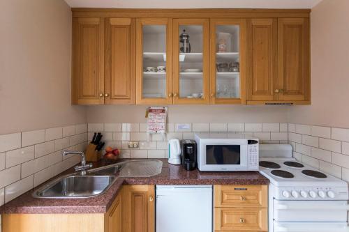 a kitchen with a sink and a microwave at Grand Old Duke in Hobart